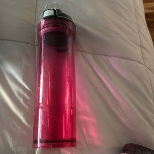 Pink see through thermos water bottle.
